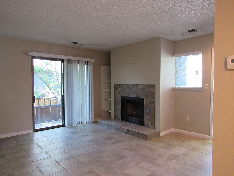Living room with fireplace and balcony