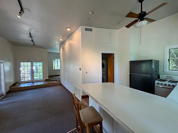 Kitchen includes refrigerator, range