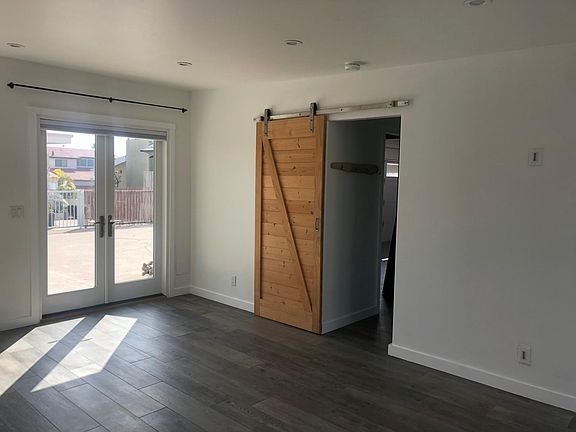 Floor is tile that looks like wood. Barn door into the bath.