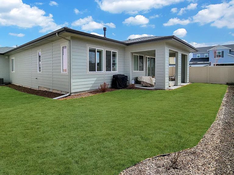 Fully fenced backyard with covered patio