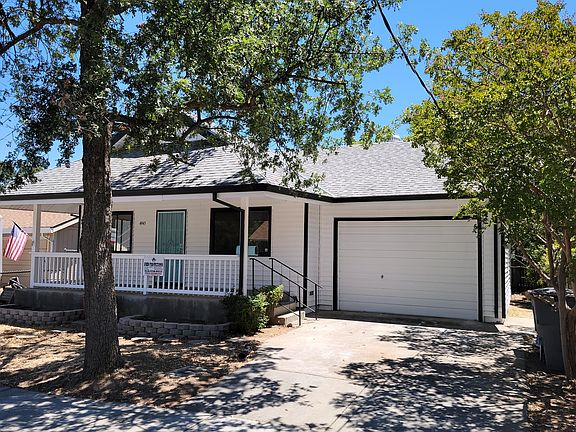 Mailbox painted to match the door. Full covered front porch - few properties have this feature! Garage is large for a car & vaulted ceilings for possible storage above. Laundry is in the back of garage at the door from the house coming down.