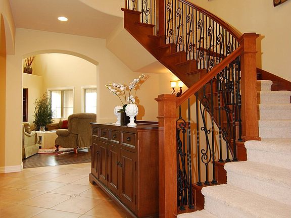 Foyer - stairwell to loft, wrought iron with stained wood balustrades