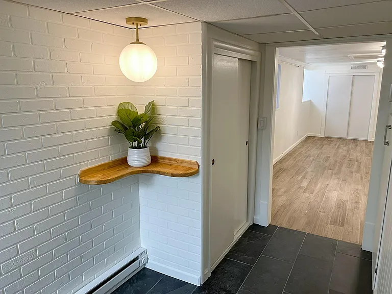 Entryway with real slate floor and convenient corner shelf