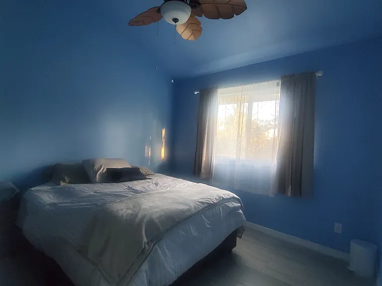 Bedroom with full bed and Chair-bed. Private bathroom with bathtub. Fan and lots of light and privacy curtains.