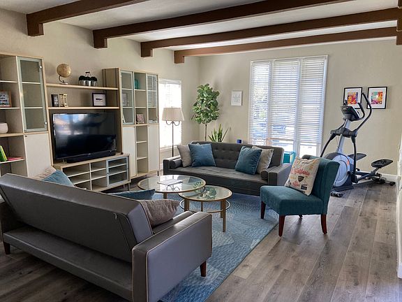 Large living room with TV and storage.