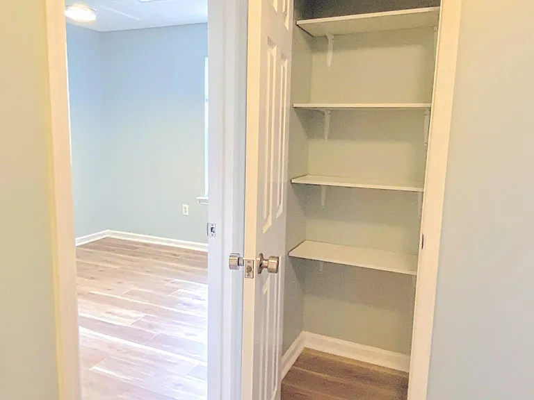 Hall linen closet and peek into the second bedroom.