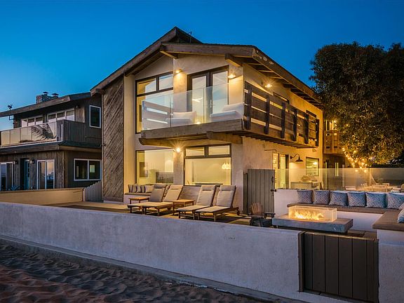 Front deck with firepit and chaise loungers on beach