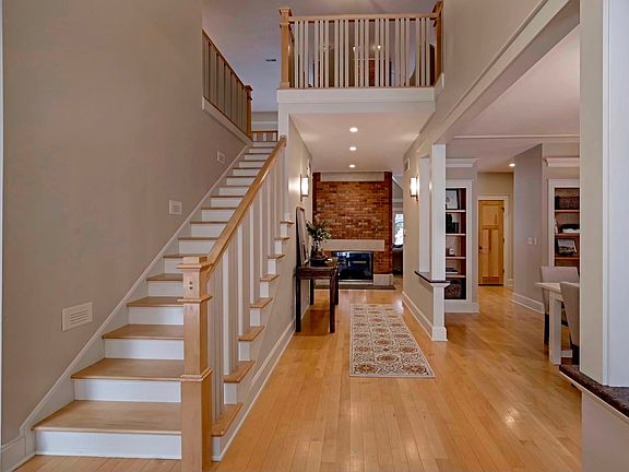 Enter the foyer, and the all wood staircase flowing up into the loft greets you, but the show-stoppe