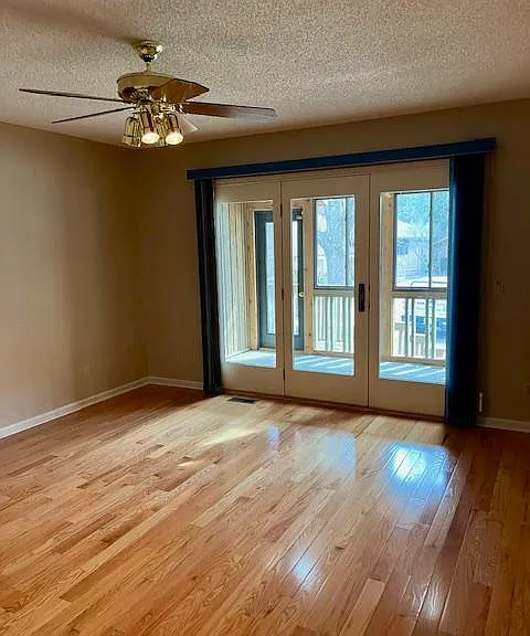 Master bedroom with access to sun room. Much larger than picture. Has a walk-in closet and attic access.