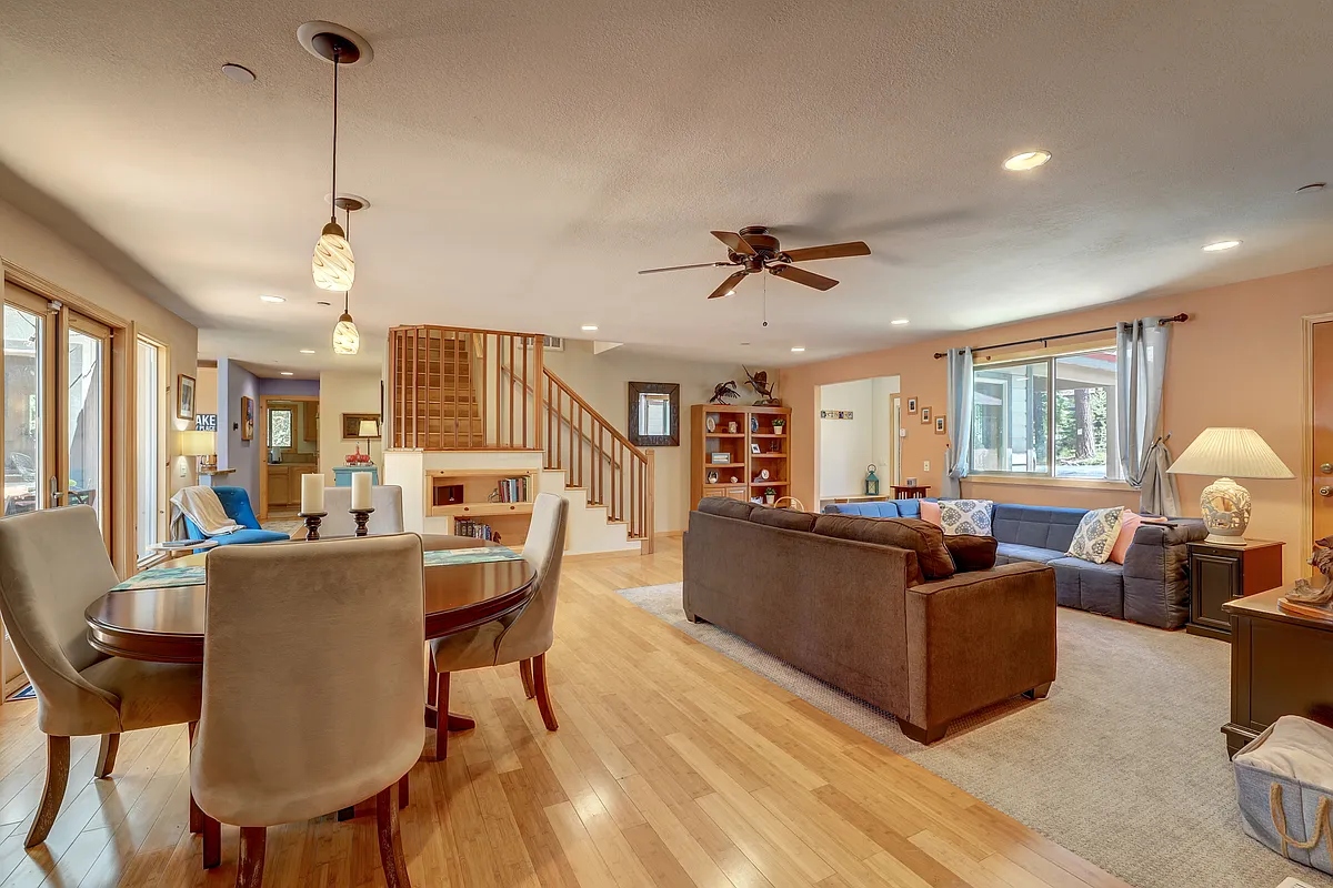 Open living area filled with natural light, warm wood floors, and flexible gathering space - 1102 Nottaway Dr