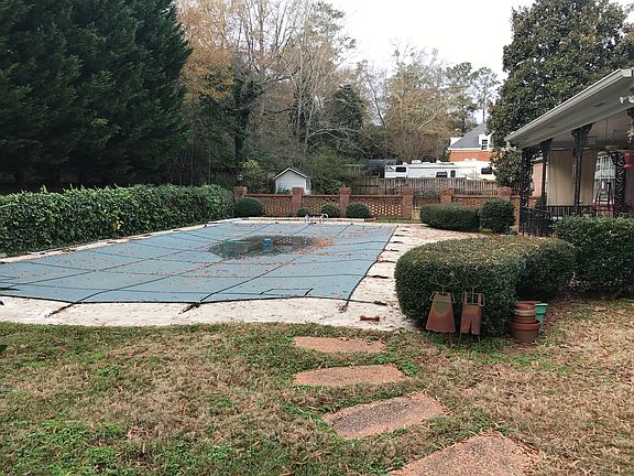 Fenced in pool with patio