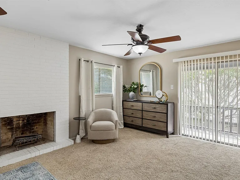 The primary bedroom has a spacious sitting area and access to a covered balcony.
