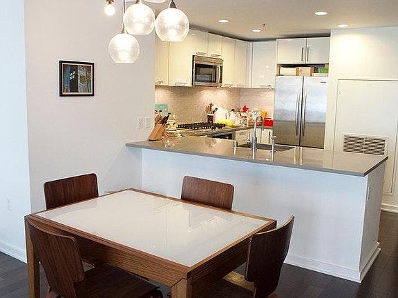 View from Dining room to Kitchen ( Staging and white paintin