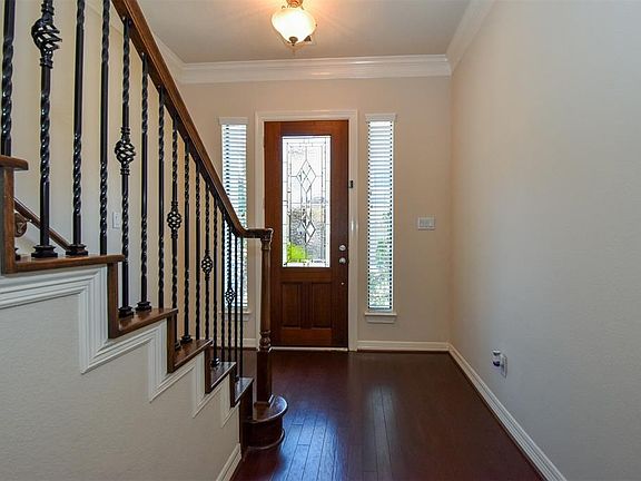 Welcome home to your new address at 11622 Royal Oaks View. Enter onto gleaming hardwood floors through a wood and glass front door graced by side lights.