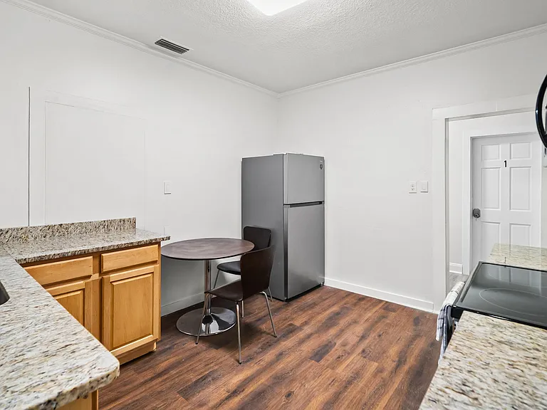 Efficient kitchen with granite-look counters, full-size fridge and range, plus a small dining nook for everyday meals.