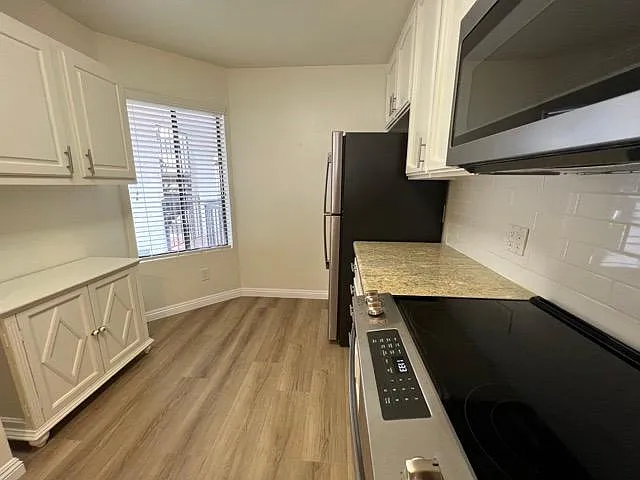 Kitchen with window overlooking front door and stairs