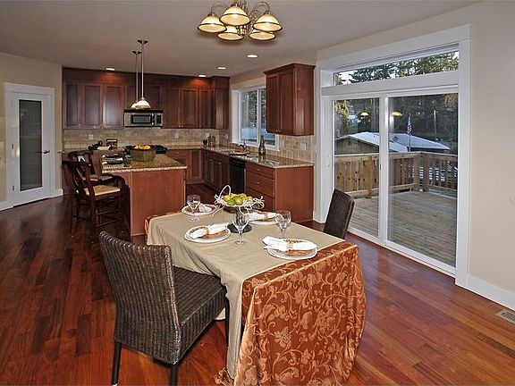 Light filled kitchen w/slab granite, travertine, cherry floors, walk-in pantry