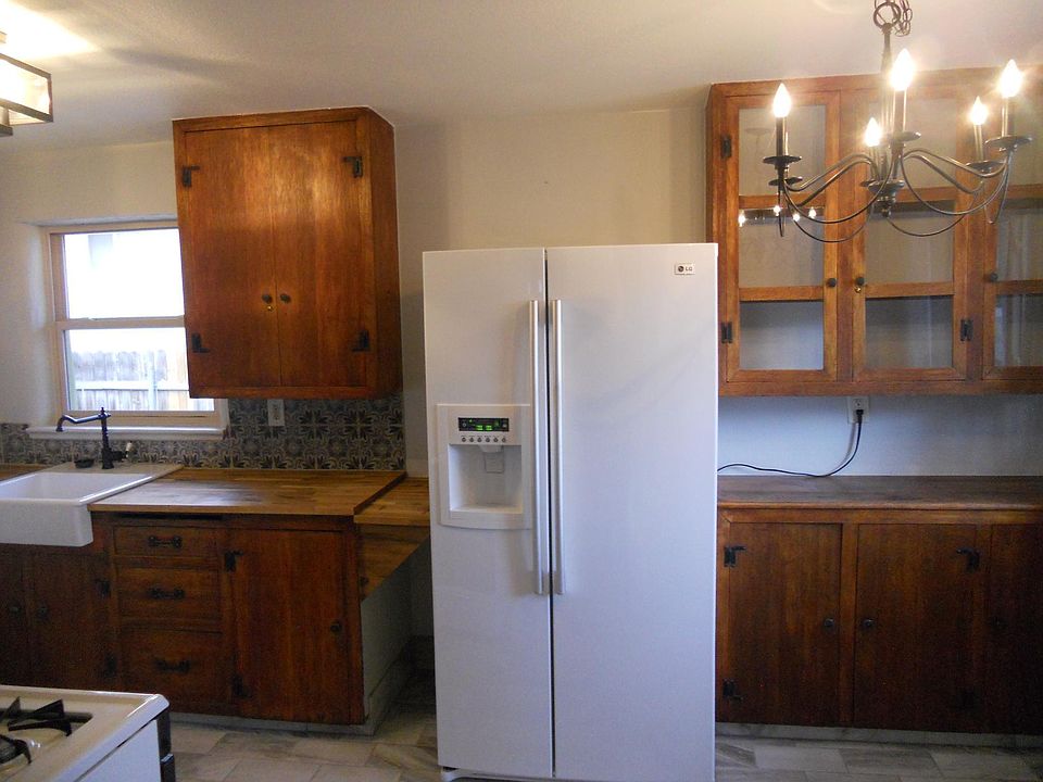 Kitchen with new refrigerator and farm house sink.