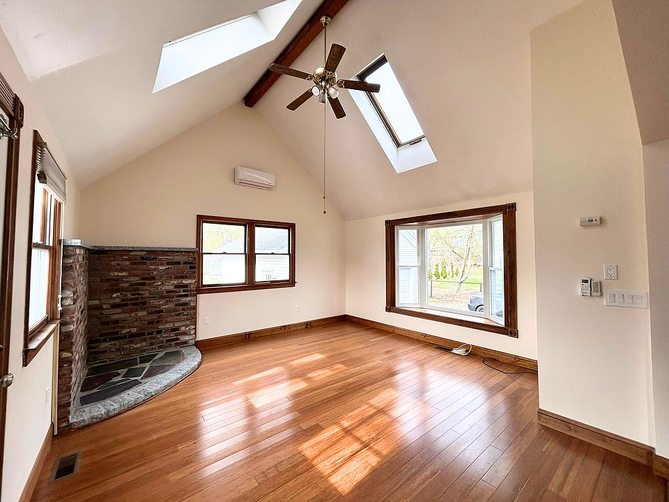 Living/Dining area with access to private back deck, ceiling fan with lights on dimmers, skylights