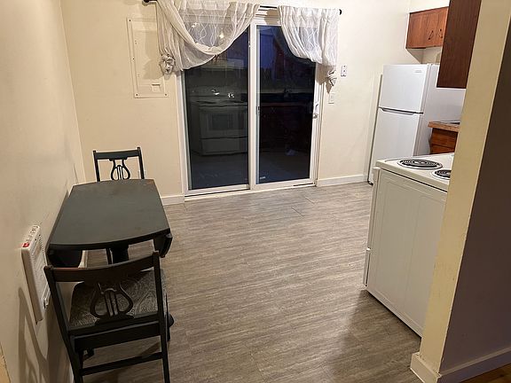 Kitchen facing sliding glass door to back patio