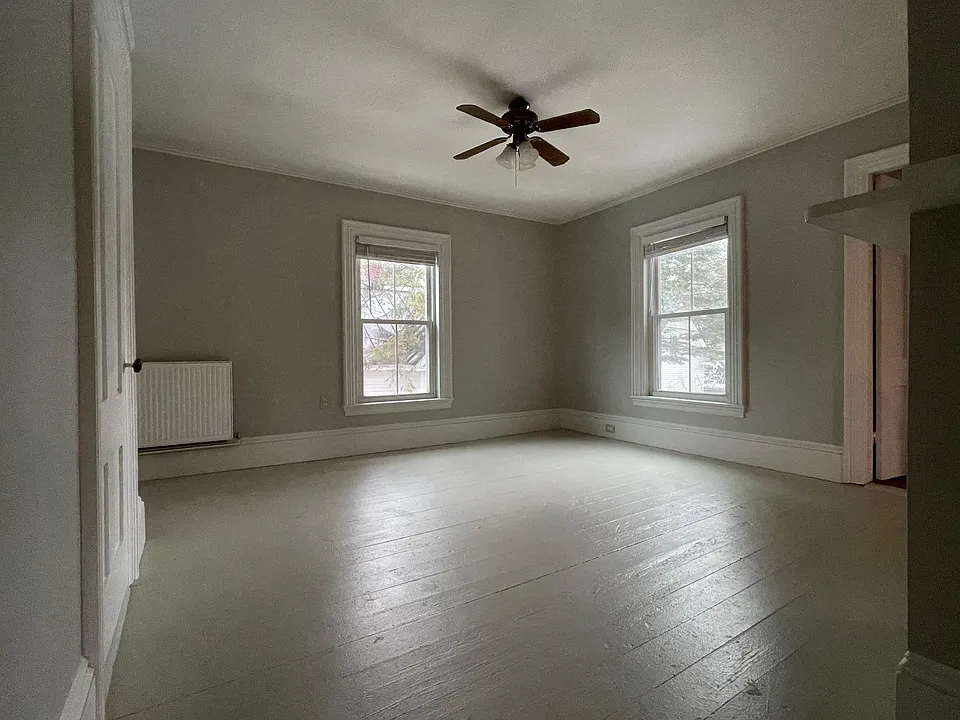 View of living room from the kitchen. There is a large closet to the left in the living room.