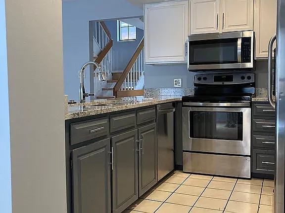 Updated kitchen with granite countertops, stainless steel appliances, and ample cabinet storage.