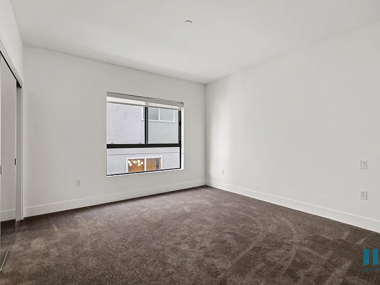 Bedroom with Mirrored Closet and Windows