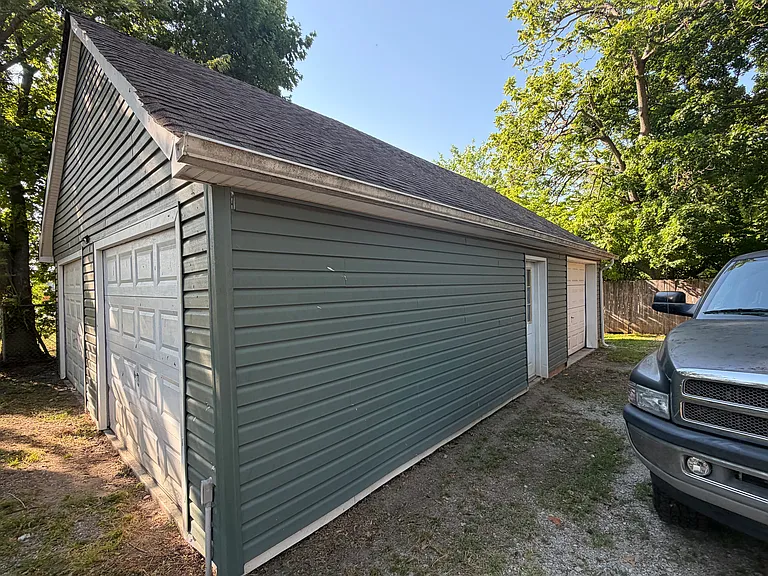 Three car garage with steps up to a loft storage area