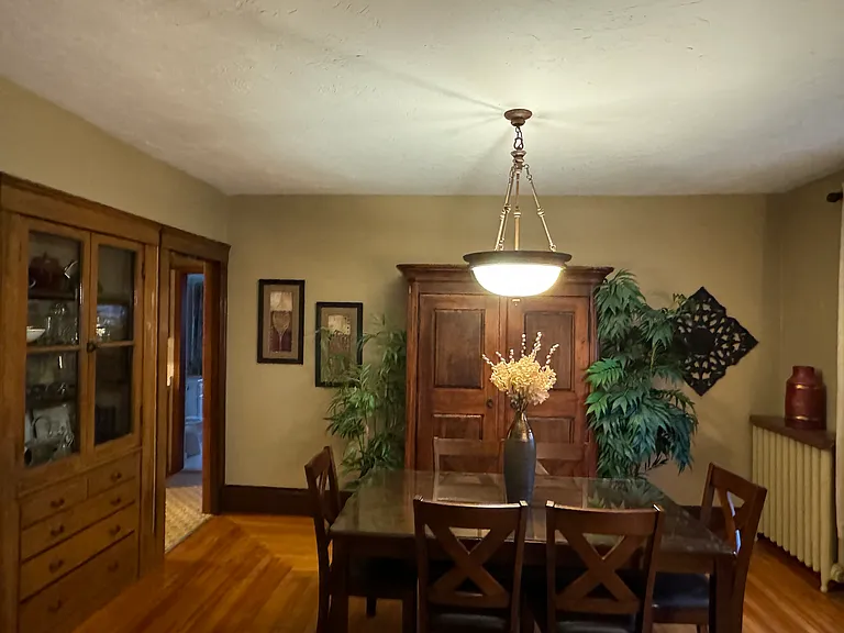 Elegant dining room to enjoy meals or can be utilized as a work space . The armoire is stocked with bath towels, a blow dryer and additional linens. The built-in hutch is stocked with wine glasses, shot glasses, presentation bowls, platters and much more.