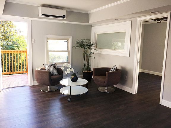 Living Room Area, View of Private Deck and Bedroom