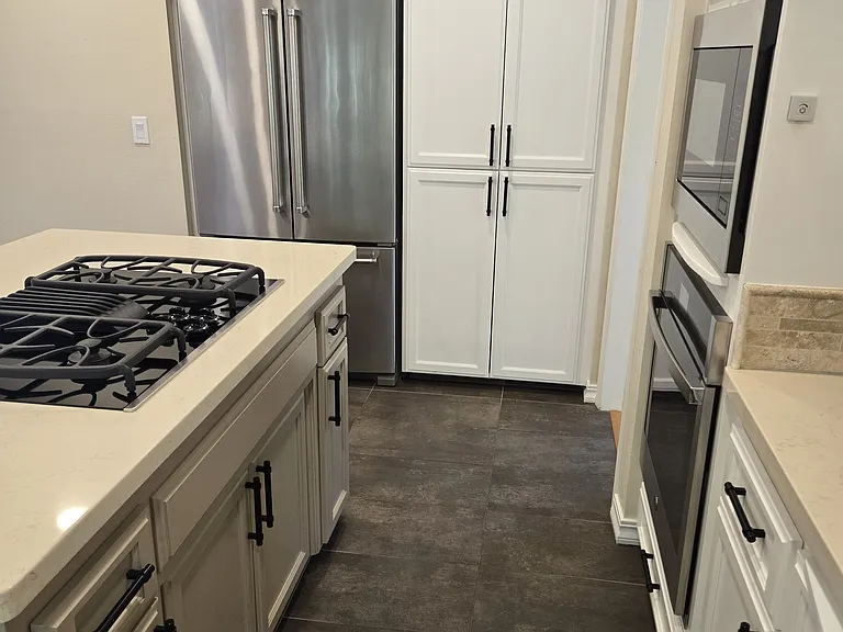 Kitchen with all stainless steel appliances and gas range.