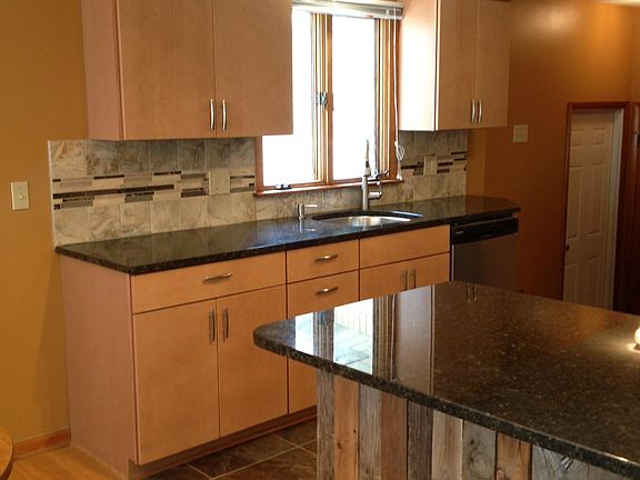 Kitchen with granite counters and tile backsplash