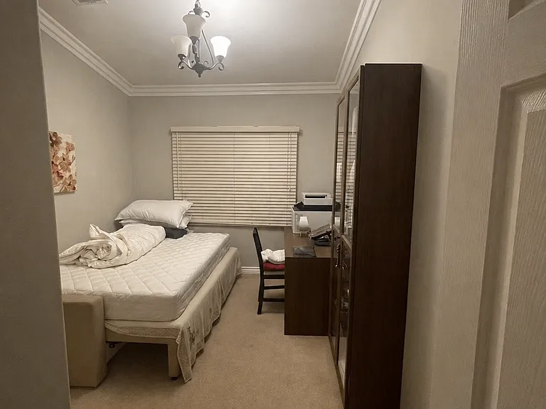 Versatile main floor flex space, ideal for a quiet home office, study, or a comfortable guest bedroom layout.