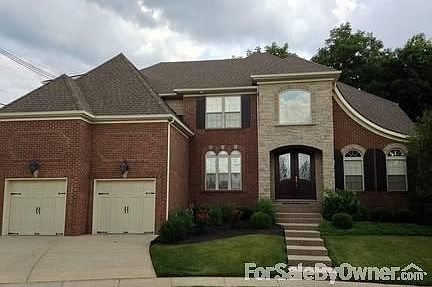 Double door entrance to 2 story European flair home with 3 car garage.