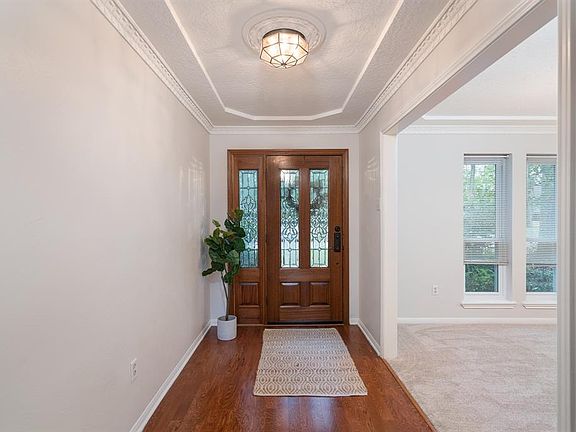 Elegant entry with wood floors and very recent paint which can be found throughout the whole home.