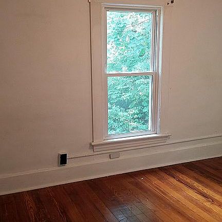 Bedroom two overlooks side yard, tree of heaven and back woo