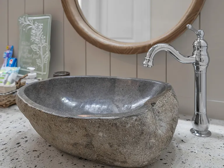 Master bathroom two natural stone vessels on quartz counter of vanity