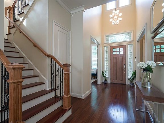 Upon entry guest are greeted with a dramatic and elegant two story foyer, stepping onto rich and warm hardwood floors, to the right is the study which could also become a formal living, and to the left is the formal dining with butler's pantry and glass d