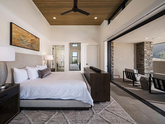 Serene primary bedroom suite with direct access to covered patio