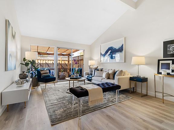 airy living area with vaulted ceiling