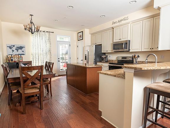 Open concept kitchen with island, breakfast bar, and granite countertops