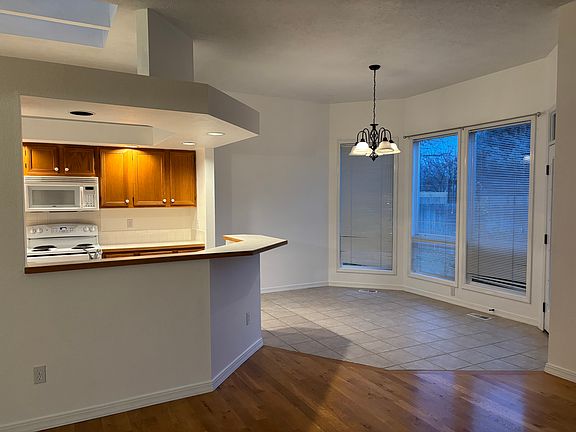 From living area looking into tiled kitchen dining area/kitchen bar.