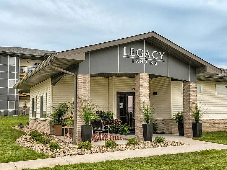 Meticulously maintained landscaping surrounds the Legacy Landing clubhouse, creating a peaceful and polished community entrance.