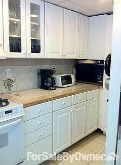 Kitchen continued
						:
						Lots of counter spce and cabinets. MaNy hidden pul-out areas.