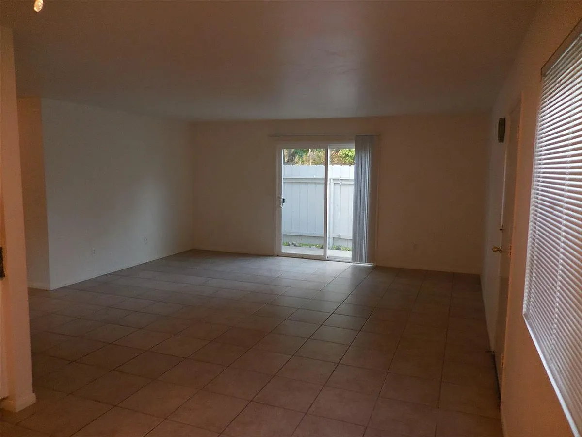 Spacious living room with glass door to the enclosed balcony - 7767 Camino Glorita