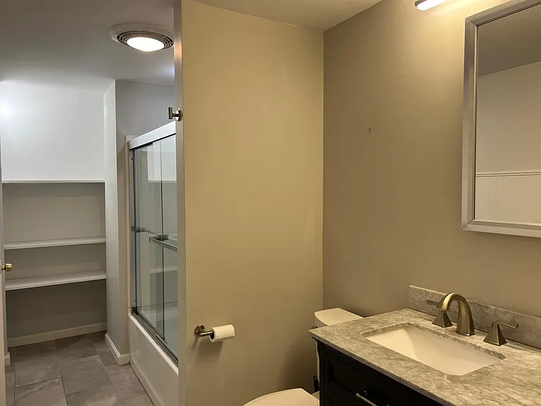 Another view of bathroom with linen storage