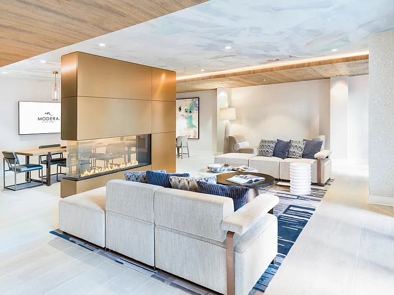 Lounge in style at Modera Liberty Row, where elegant design and cozy fireplace seating create the perfect Charlotte retreat.