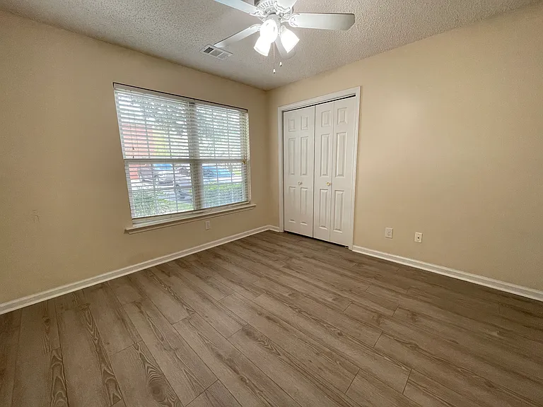 Spacious second bedroom with attached closet and ample natural light