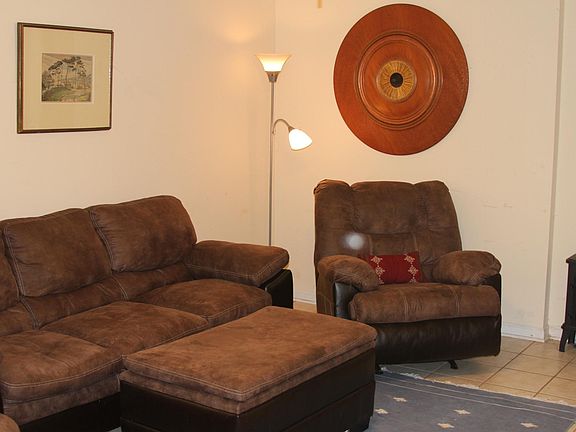 Lie back on reclining chairs and enjoy Roku TV with wood burning stove (well it looks like a wood burning stove).