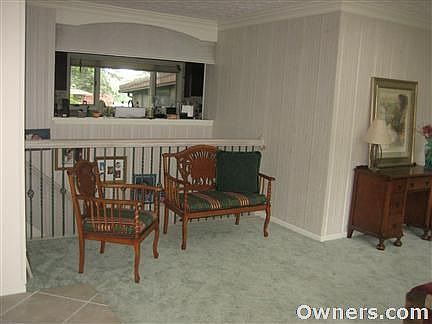 Front room looking into kitchen and out at Lake front